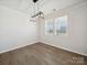 Neutral living room showcasing luxury vinyl plank flooring, light walls, and modern lighting fixture at 1207 Laggan Ln, Indian Trail, NC 28079