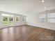 Bright living room with wood floors, large windows, and French doors leading to outdoor space at 1207 Laggan Ln, Indian Trail, NC 28079