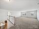 Spacious loft area with large windows and plush carpeting, offering a flexible living space at 1207 Laggan Ln, Indian Trail, NC 28079