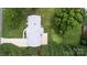 Aerial view of a home with a well-maintained roof, landscaping, and extended driveway at 1216 Manchester Ln, Charlotte, NC 28227