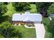 Aerial view of the home with a new roof, landscaping, driveway, and spacious surrounding greenery at 1216 Manchester Ln, Charlotte, NC 28227