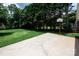 A well-maintained lawn with lush trees and a basketball hoop for outdoor fun at 1216 Manchester Ln, Charlotte, NC 28227