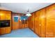 Cozy dining room features wood paneling, blue carpet, and built in cabinets at 1216 Manchester Ln, Charlotte, NC 28227