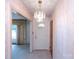 Inviting entryway with a chandelier, wallpaper, and view to the adjacent living room at 1216 Manchester Ln, Charlotte, NC 28227