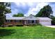Charming brick home featuring a well-manicured lawn, landscaping, and an attached two-car garage at 1216 Manchester Ln, Charlotte, NC 28227