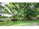 Spacious backyard with lush green grass and mature trees, creating a serene and private outdoor space at 1227 Flowe Dr, Matthews, NC 28104