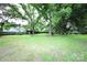Expansive backyard with lush green grass, mature trees, and a shed, creating a serene outdoor oasis at 1227 Flowe Dr, Matthews, NC 28104