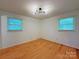 Inviting bedroom with hardwood floors and two windows, offering ample natural light and a cozy atmosphere at 1227 Flowe Dr, Matthews, NC 28104