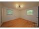 Bright bedroom with hardwood floors, natural light, and neutral walls, ready for personalization and decor at 1227 Flowe Dr, Matthews, NC 28104
