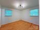 Bright bedroom with hardwood floors, natural light, and neutral walls, ready for personalization and decor at 1227 Flowe Dr, Matthews, NC 28104