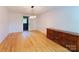 Spacious bedroom featuring an ornate wooden dresser and hardwood flooring at 1227 Flowe Dr, Matthews, NC 28104