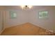 Inviting bedroom features hardwood flooring and a modern ceiling light at 1227 Flowe Dr, Matthews, NC 28104
