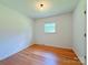 Bright bedroom with hardwood floors and a window offering natural light at 1227 Flowe Dr, Matthews, NC 28104