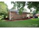 Brick house featuring an expansive green lawn and a rear deck at 1227 Flowe Dr, Matthews, NC 28104