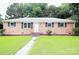 Charming brick home featuring a well-manicured lawn and inviting walkway at 1227 Flowe Dr, Matthews, NC 28104