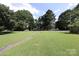 Expansive front yard showcasing lush green grass, creating a welcoming entrance to the home with ample space at 1227 Flowe Dr, Matthews, NC 28104