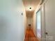 Hallway with hardwood floors, leading to other areas of the home at 1227 Flowe Dr, Matthews, NC 28104