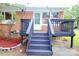 Exterior shot showing a brick home with a gray rear deck, with stairs leading up to the white back door at 1227 Flowe Dr, Matthews, NC 28104