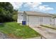 Home boasts large yard with detached garage, greenery and partial hardscape at 12342 Swan Wings Pl, Huntersville, NC 28078
