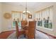 Bright dining area with a glass table, wicker chairs, and large windows at 12342 Swan Wings Pl, Huntersville, NC 28078
