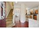 Inviting entryway with hardwood floors, staircase, and a view into the living spaces at 12342 Swan Wings Pl, Huntersville, NC 28078