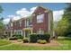 Well-maintained townhome with brick and siding, complemented by lush green lawn at 12342 Swan Wings Pl, Huntersville, NC 28078
