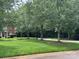Inviting front yard with lush green lawn and mature trees providing ample shade at 12342 Swan Wings Pl, Huntersville, NC 28078