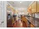 Modern kitchen featuring stainless steel appliances, wood cabinets, and views of the dining area at 12342 Swan Wings Pl, Huntersville, NC 28078