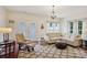 Well-lit living room with french doors, a comfortable sectional sofa, and elegant decor at 12342 Swan Wings Pl, Huntersville, NC 28078