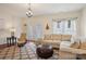 Bright living room featuring a neutral color scheme, stylish furniture, and a decorative chandelier at 12342 Swan Wings Pl, Huntersville, NC 28078
