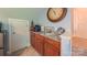 Cozy bar area with wooden cabinets, granite countertop, and display shelves, with decor at 1240 Fawn Ridge Nw Rd, Concord, NC 28027