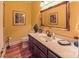 Well-appointed powder room with a decorative mirror, stylish sink, and tasteful decor for guests at 1240 Fawn Ridge Nw Rd, Concord, NC 28027
