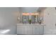 Bright bathroom featuring double sinks with white cabinets, modern fixtures, and ample counter space at 1240 Fawn Ridge Nw Rd, Concord, NC 28027