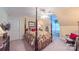 Bedroom with a four-poster bed, soft lighting, and a cozy reading nook with a rocking chair at 1240 Fawn Ridge Nw Rd, Concord, NC 28027