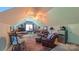Bonus room with a seating area, bar, and casual dining table, with a ceiling fan and natural light at 1240 Fawn Ridge Nw Rd, Concord, NC 28027