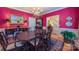 Formal dining room with a chandelier, elegant furniture, and vibrant red walls for memorable gatherings at 1240 Fawn Ridge Nw Rd, Concord, NC 28027