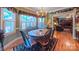 Light-filled dining area with hardwood floors, a decorative rug, and views into the adjacent living room at 1240 Fawn Ridge Nw Rd, Concord, NC 28027