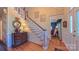 Classic foyer with a staircase, hardwood floors, and elegant decor leading into other rooms of the house at 1240 Fawn Ridge Nw Rd, Concord, NC 28027