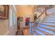 Welcoming foyer with a staircase, hardwood floors, and decorative lighting offering a glimpse into the dining room at 1240 Fawn Ridge Nw Rd, Concord, NC 28027