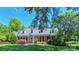 Beautiful red brick home features dormer windows and a perfectly manicured lawn at 1240 Fawn Ridge Nw Rd, Concord, NC 28027