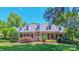 Beautiful red brick home features dormer windows and a perfectly manicured lawn at 1240 Fawn Ridge Nw Rd, Concord, NC 28027