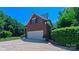 Spacious two-car garage attached to the brick home with a well-manicured lawn at 1240 Fawn Ridge Nw Rd, Concord, NC 28027