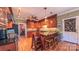 Spacious kitchen featuring custom wood cabinets, granite countertops, stainless steel appliances, and barstool seating at 1240 Fawn Ridge Nw Rd, Concord, NC 28027