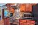 Close-up view of kitchen appliances and counters showcasing the stainless steel range, microwave, and wood cabinets at 1240 Fawn Ridge Nw Rd, Concord, NC 28027