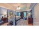 Spacious main bedroom with a four-poster bed, sitting area, tray ceiling, and ample natural light at 1240 Fawn Ridge Nw Rd, Concord, NC 28027