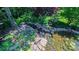 Landscaped backyard pond with lush greenery, rock borders, and serene water features at 1240 Fawn Ridge Nw Rd, Concord, NC 28027