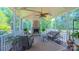 Relaxing sunroom featuring a stone fireplace, comfortable seating, and panoramic views of the surrounding greenery at 1240 Fawn Ridge Nw Rd, Concord, NC 28027