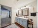 Bathroom with a blue vanity, wooden-look floors and modern lighting fixtures at 1252 Winding Path Rd, Lake Wylie, SC 29710