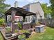 Relax on the home's deck, featuring a comfortable outdoor seating area with lush landscaping at 1252 Winding Path Rd, Lake Wylie, SC 29710