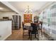 Cozy dining area with modern chandelier, wooden hutch, and large windows with sheer curtains at 1252 Winding Path Rd, Lake Wylie, SC 29710